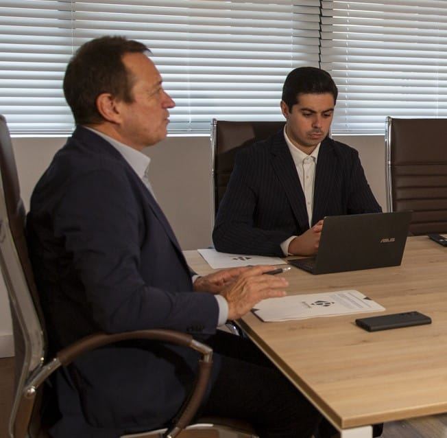 Juan Bertomeu and Daniel Bertomeu reviewing a case in the Expat Abogados meeting room